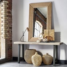 a mirror and some baskets on a table