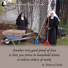 two women dressed in black holding shovels next to a wheelbarrow