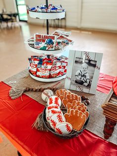 baseball themed cookies are displayed on a table in front of a card and other items