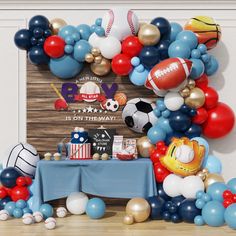 a table with balloons and footballs on it