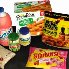 some food items are sitting on a black counter top with milk, eggs, and other ingredients