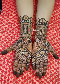 the hands and feet of a woman with henna tattoos