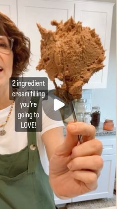 a woman holding a flower in her hand with the caption, 2 ingredient cream filling you're going to love