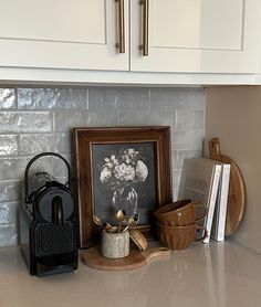 the kitchen counter is clean and ready to be used as a coffee maker, teapot, bookends, and other items