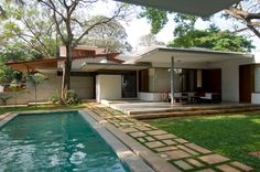 a house with a swimming pool in front of it