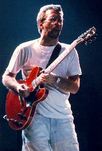 a man playing an electric guitar on stage