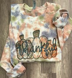 Thankful cute pumpkins fall Tie dye sweatshirt, -This is Sublimation design direct to garment print onto TIE DYE color sweatshirt,  -Sweatshirt is 50%cotton and 50%polyester. -This is unisex sweatshirt: Size chart is listed in images!  -Size up for oversize look! **Shirt is made to order, and processing times is estimated 3-5 business days! Please order ahead  *Due to nature of Handmade goods this order is not allowed for returns or exchanges, but if you have any concerns, please do contact me a Soft-washed Acid Wash Tops For Fall, Multicolor Graphic Print Fall Sweatshirt, Casual Multicolor Fall Sweatshirt, Multicolor Crew Neck Sweatshirt For Fall, Fall Letter Print Multicolor Sweatshirt, Fall Hand Dyed Relaxed Fit Tops, Acid Wash Cotton Sweatshirt For Fall, Tie Dye Cotton Tops For Fall, Hand Dyed Relaxed Fit Sweatshirt For Fall