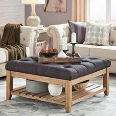 a living room filled with furniture and a coffee table on top of a rug covered floor