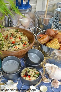 there are many dishes on the table with shells and other things to eat in them