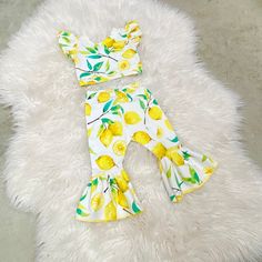 "Beautiful lemons bell pants and crop top. Perfect for lemonade themed birthdays.  The set is made of cotton lycra stretchy knit fabric. Runs true to size. I won't recommend sizing up.  Size-inseam of leggings/waist  NB-6\"/13\" 0-3m-7\"/14.5\" 3-6m-8\"/15.5\" 6-9m- 9\"/16\" 9-12m-10.5\"/16.5\" 12-18m-11.5\"/17.25\" 18-24m-13\"/18\" 2-3t-14.5\"/18.5 3-4t-15\"/19\" 4-5y-15.5\"/19.5\" 5-6y-16\"/20\"" Spring Fun Fitted Sets, Fun Yellow Summer Sets, Yellow Stretch Sets For Spring, Playful Yellow Fitted Sets, Fitted Yellow Playful Sets, Playful Fitted Yellow Sets, Cute Fitted Yellow Bottoms, Bell Pants, Lemonade Stand