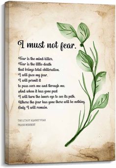 a poem written on parchment paper with green leaves and the words i must not fear