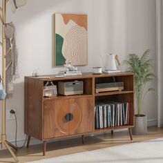 a room with a book shelf, bookshelf and pictures on the wall above it