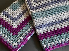 two crocheted dishcloths sitting next to each other on top of a table