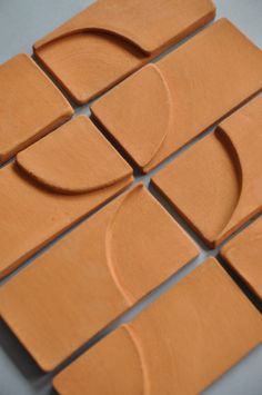 several pieces of clay sitting on top of each other in the shape of circles and rectangles