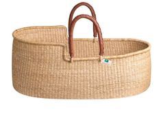 a baby bassinet that is made out of straw and has a handle on it