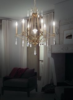 a chandelier hanging from the ceiling in a living room