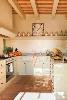 a kitchen with an oven, sink, and counter top in the middle of it