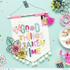 a banner that says good things take time next to other crafting supplies and flowers