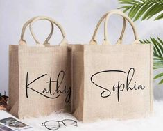 two personalized bags with the names of people on them, sitting next to each other