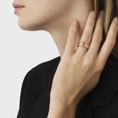 a close up of a person wearing a gold ring