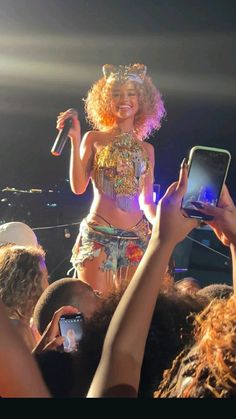 a woman in a costume holding up her cell phone