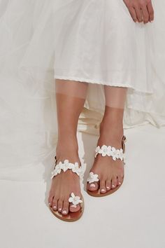 Our Anthousa beach wedding flat shoes are the perfect ladylike wedding flats that also infuses comfort. These shoes for bride are handmade of top quality gold leather. They feature a thin instep strap and a toe ring topped with ivory lace flowers, hand-beaded with pearls. Anthousa also has the lightest outsole and adjustable buckle closure for secure fitting. Our sandals for beach wedding provide comfort, beauty, and elegance all at once. They can also be a perfect choice for a wedding guest. Summer Wedding Flats With Ankle Strap, Summer Wedding Ankle Strap Flats, Open Toe Summer Wedding Flats, Summer Wedding Open Toe Flats, Open Toe Flats For Summer Weddings, Summer Wedding Flats With Round Toe, Flat Sandals For Spring Wedding, Summer Wedding Flats, Spring Wedding Sandals With Flat Heel