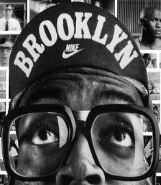 a man wearing glasses and a hat with the words brooklyn printed on it's forehead