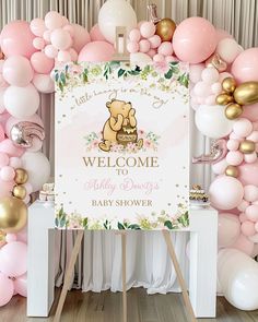 a welcome baby shower sign surrounded by balloons