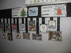 a bulletin board with pictures hanging on it's side and a clock mounted to the wall