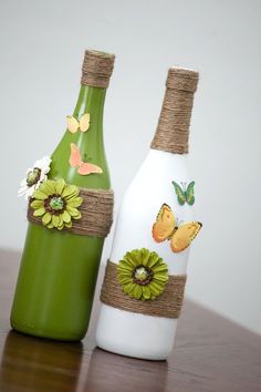 two bottles with flowers and butterflies painted on them