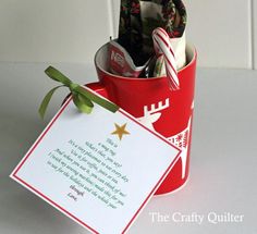 a red bucket filled with candy canes next to a card