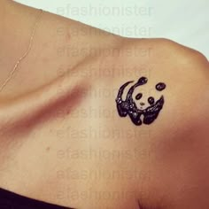 a woman with a tattoo on her shoulder that has an image of a panda bear