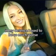 a woman sitting in the back seat of a car