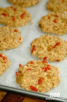 cookies with red peppers are on a baking sheet and ready to be baked in the oven