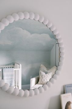 a baby's room with a large mirror on the wall