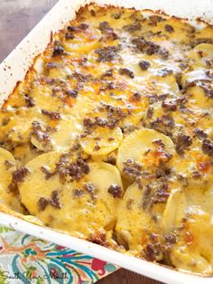 a casserole dish filled with cheese and meat