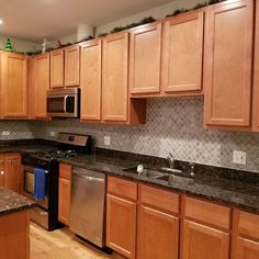 a kitchen with wooden cabinets and granite counter tops