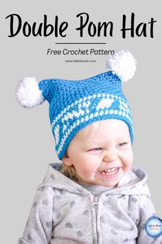 a baby wearing a blue and white knitted hat with pom - poms