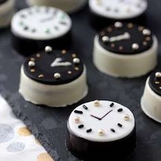 some black and white cakes are on a table