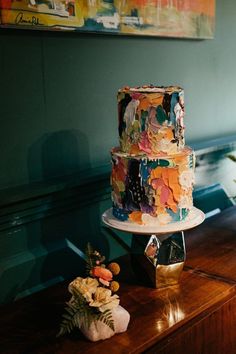 a wedding cake sitting on top of a wooden table