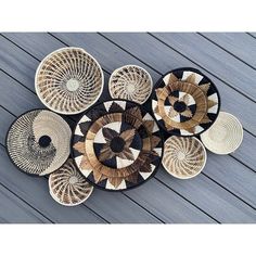 several woven baskets sitting on top of a wooden floor