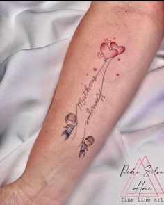 a woman's arm with a tattoo on it that says motherhood and hearts