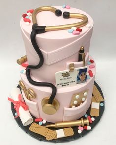 a pink cake with gold trimmings and decorations