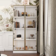 a white book shelf with books on it in front of a wallpapered background