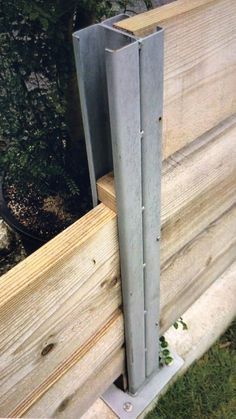 a piece of wood that has been placed on the side of a building with metal posts