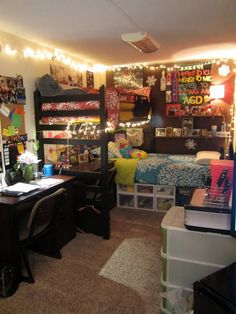 a dorm room with lights strung from the ceiling and various items on the desks