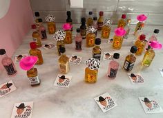 several bottles of liquor are arranged on the counter with stickers in front of them