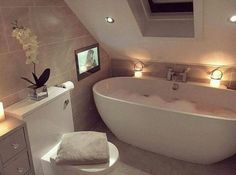 a bath room with a large tub and a tv on the wall next to it