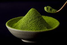 green powder in a bowl with a spoon