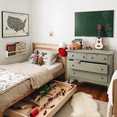 a child's bedroom with toy cars and toys in the drawer on the bed